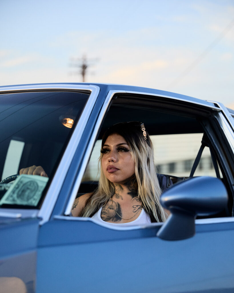 © Owen Harvey, 'Jesssica sits in her Cutlass at a lowrider cruise in downtown LA'