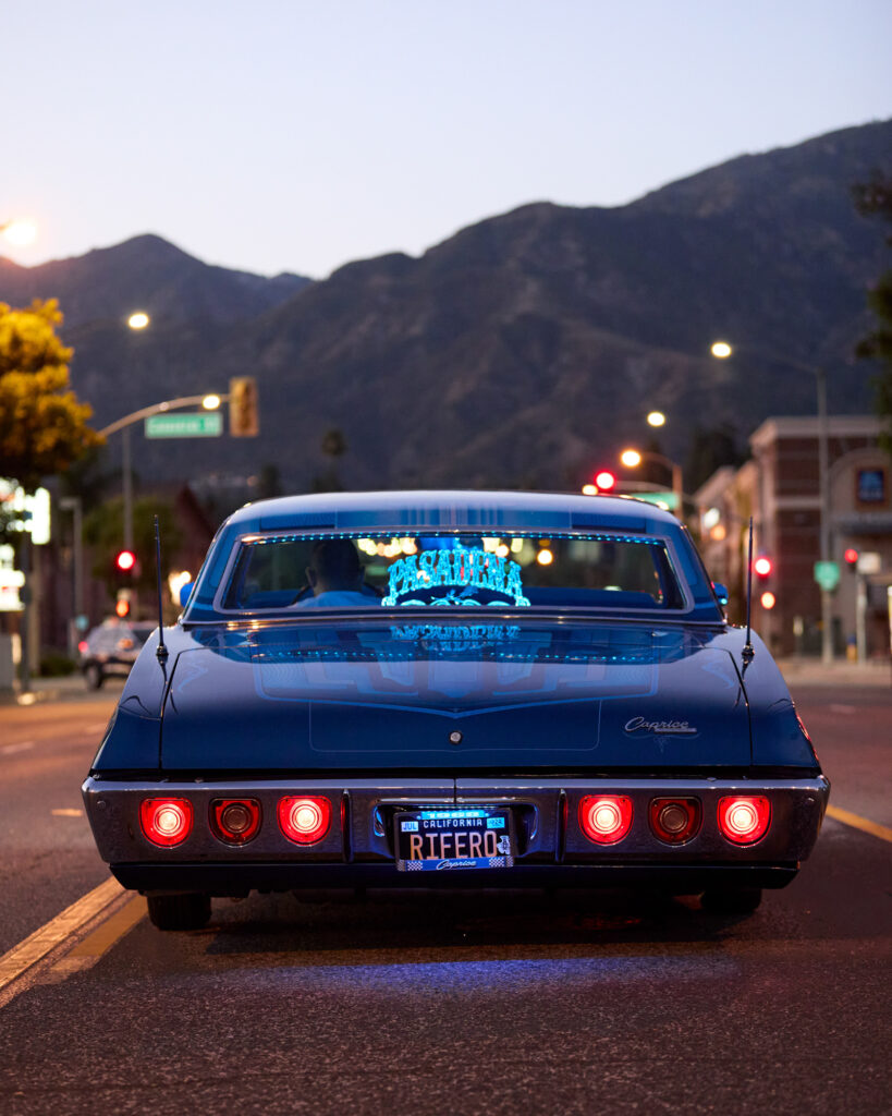 © Owen Harvey, 'A member of Pasadena CC sits in his car on the road in Altadena in front of the mountains'