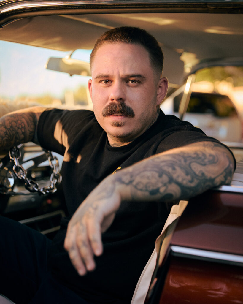 © Owen Harvey, 'Jodye from Genocide CC sits in his lowrider.'