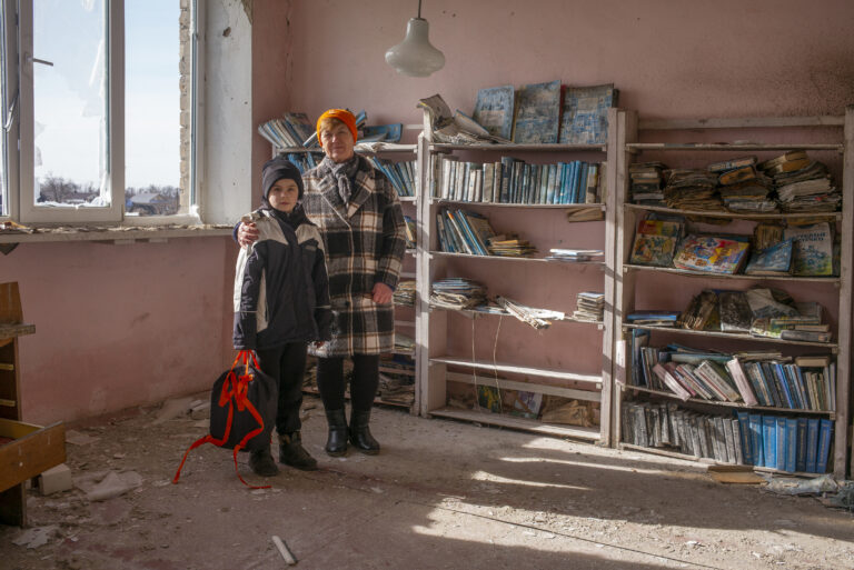 Nadya and Dmity, in the destroyed library of Myrne, Kherson fronlines. © Danny Burrows